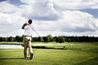 Golf player teeing off