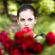 Woman with red lips giving flowers