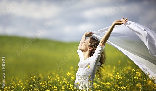 Photo: Woman with white piece of cloth in wind Woman with white piece of cloth in wind