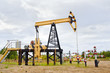Pump jack and oil well. Pump jack and oil well.