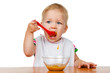 canvas print picture - girl eats with a spoon