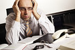 Foto: Worried businessman at desk Worried businessman at desk