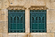 two windows with grills