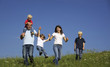 Family walking in field playing with children Family walking in field playing with children