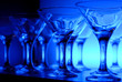 Wineglasses arranged in rows on the table in blue light Wineglasses arranged in rows on the table in blue light