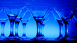 Wineglasses arranged in rows on the table in blue light Wineglasses arranged in rows on the table in blue light