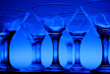 Wineglasses arranged in rows on the table in blue light Wineglasses arranged in rows on the table in blue light