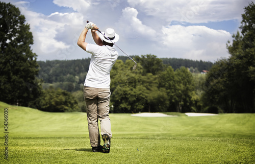 Photo: Man teeing-off golf ball. Man teeing-off golf ball.
