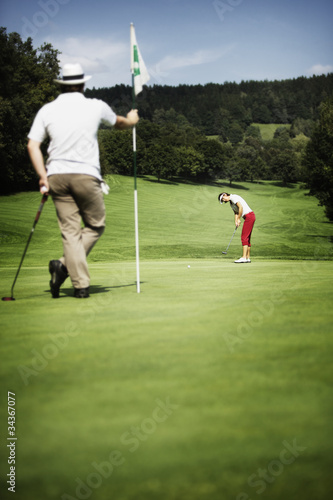 Photo: Two golfer on green Two golfer on green