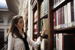 Student looking for a book in library.