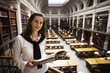 Friendly student reading in library upstairs. Friendly student reading in library upstairs.