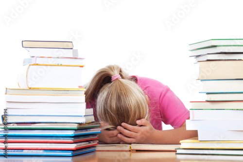 Foto: schoolgirl frustated between many books schoolgirl frustated between many books