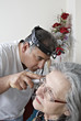 Doctor exam mature patient ear