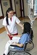 Female nurse help female patient on wheelchair