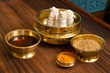 herbs powder and oil in bronze cups