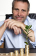 Happy businessman pleased about prosperous business growth.