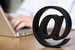 Foto: Close up of at symbol with laptop. Close up of at symbol with laptop.