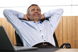 Smiling manager relaxing in office chair.