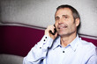 Happy business executive chatting on mobile phone.