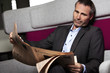 Businessman reading newspaper in break.