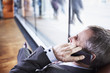 Manager talking on phone with busy people in background.