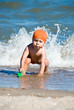 Boy body surfing in the sea