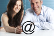 At letter with business woman and man.