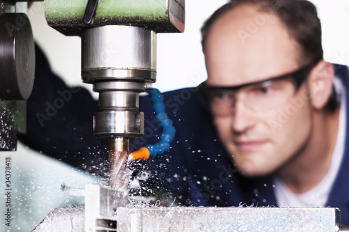 Photo: Macro of laborer at milling machine. Macro of laborer at milling machine.