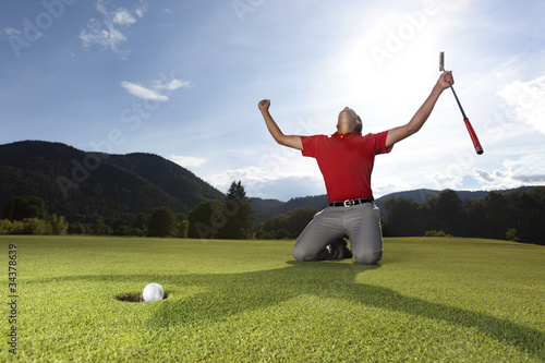 Photo: Happy golf player on geen. Happy golf player on geen.