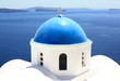 blue dome of a church in village of oia, santorini