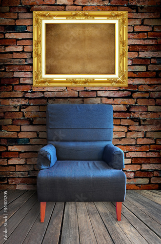 Photo: old single sofa seat and frame in front of the wall old single sofa seat and frame in front of the wall