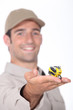 young man presenting a miniature scooter model