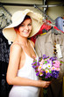 Portrait of a Young Woman with flowers. Standing in a Clothing S