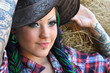 young tattooed  stylish woman with dreadlocks in cowgirl style