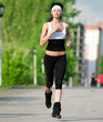 Woman running in green park Woman running in green park