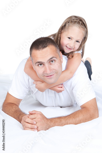 Photo: Father and little daughter lying on a bed Father and little daughter lying on a bed
