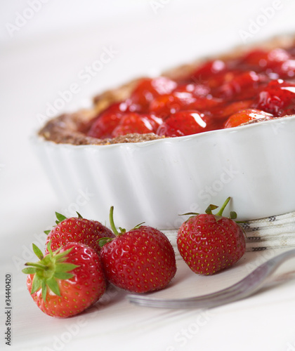 Photo: sweet strawberry pie on a white table sweet strawberry pie on a white table