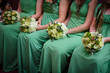 Row of bridesmaids with bouquets at wedding ceremony