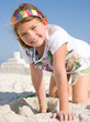Child Building Sandcastle on a Beach