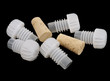 Plastic and wood corks for home wine making, isolated on black Plastic and wood corks for home wine making, isolated on black