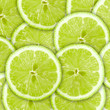 Abstract green background with citrus-fruit of lime slices Abstract green background with citrus-fruit of lime slices