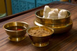 herbs powder and oil in bronze cups