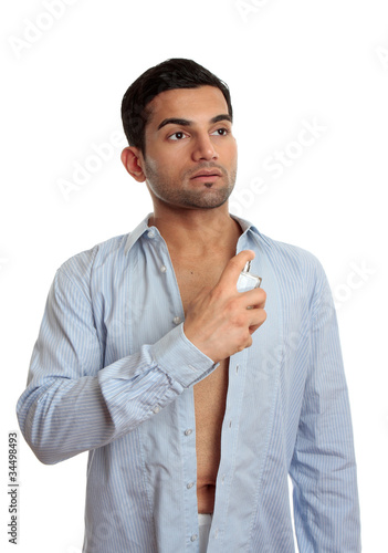 Photo: Man spraying cologne Man spraying cologne