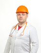 A man in a white coat, helmet and phonendoscope. A man in a white coat, helmet and phonendoscope.