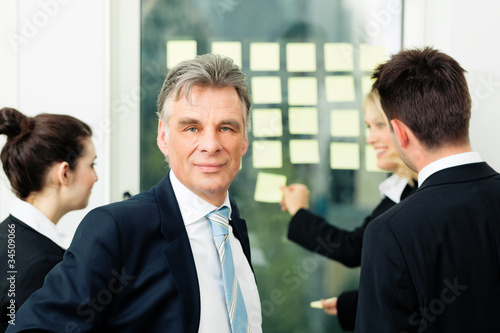 Photo: Business Team with leader in office Business Team with leader in office
