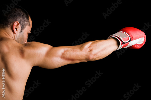 Photo: Young Boxer fighter over black background Young Boxer fighter over black background