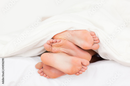 Photo: Stack of feet in a bed Stack of feet in a bed