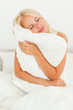 Blonde woman holding a pillow