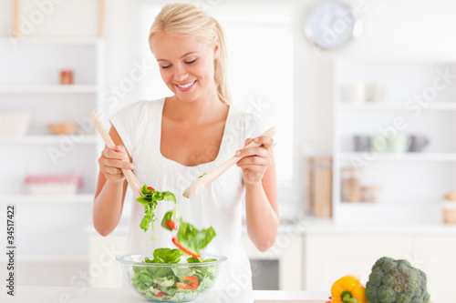 Photo: Gorgeous woman mixing a salad Gorgeous woman mixing a salad