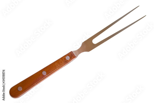 Photo: Large fork with wooden handle on a white Large fork with wooden handle on a white